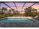 Relaxing screened pool with patio and lounge chairs at 42115 Edgewater Dr, Punta Gorda, FL 33982