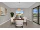 Modern dining room with wood table, chandelier, and pool view at 4218 Vasco St, Punta Gorda, FL 33950