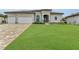 Two-story home with tile roof, three-car garage, and spacious lawn at 4218 Vasco St, Punta Gorda, FL 33950