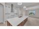 Modern kitchen with large island, white cabinets, and quartz countertops at 4218 Vasco St, Punta Gorda, FL 33950
