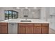Kitchen island with sink, dishwasher, and white quartz countertops at 4218 Vasco St, Punta Gorda, FL 33950