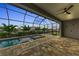 Evening view of a screened-in pool and spa at 4218 Vasco St, Punta Gorda, FL 33950