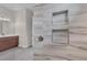 Shower with marble-like wall tiles and built-in shelves at 4218 Vasco St, Punta Gorda, FL 33950