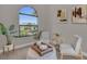 Cozy sitting area with arched window, hardwood floors, and stylish decor at 4218 Vasco St, Punta Gorda, FL 33950