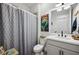 Clean bathroom with white vanity, shower, and mermaid themed art at 43620 Sparrow Dr, Punta Gorda, FL 33982