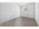 Empty bedroom with grey wood-look tile flooring and a window at 43620 Sparrow Dr, Punta Gorda, FL 33982