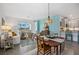 Bright dining area with wooden table and chairs, view into living room at 43620 Sparrow Dr, Punta Gorda, FL 33982