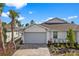 Craftsman style home with gray garage door and landscaped front yard at 43620 Sparrow Dr, Punta Gorda, FL 33982