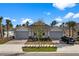 Two-story home with gray garage doors and nicely landscaped yards at 43620 Sparrow Dr, Punta Gorda, FL 33982