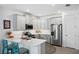 L-shaped kitchen with white cabinets, stainless steel appliances, and a large island at 43620 Sparrow Dr, Punta Gorda, FL 33982