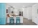 Modern kitchen with white cabinets, stainless steel appliances, and teal accents at 43620 Sparrow Dr, Punta Gorda, FL 33982