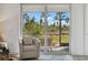 View of a screened-in patio and lush green landscape at 43620 Sparrow Dr, Punta Gorda, FL 33982
