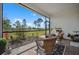 Screened porch with wicker furniture and a view of the backyard at 43620 Sparrow Dr, Punta Gorda, FL 33982