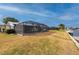 Large backyard with canal access and screened enclosure at 450 Capri Isles Ct, Punta Gorda, FL 33950