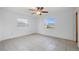 A bedroom with tile flooring and a ceiling fan at 450 Capri Isles Ct, Punta Gorda, FL 33950