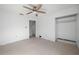 A bedroom with tile floors, ceiling fan, and a closet at 450 Capri Isles Ct, Punta Gorda, FL 33950