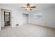 A spacious bedroom with tile floors, a ceiling fan, and a large closet at 450 Capri Isles Ct, Punta Gorda, FL 33950