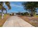 Front view of single story home with circular driveway at 450 Capri Isles Ct, Punta Gorda, FL 33950