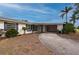 White single story home with carport and mature landscaping at 450 Capri Isles Ct, Punta Gorda, FL 33950