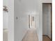 A freshly painted hallway with tile floors and built-in shelving at 450 Capri Isles Ct, Punta Gorda, FL 33950
