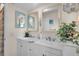 Updated bathroom with double vanity and stylish mirrors at 745 Kellstadt Nw St, Port Charlotte, FL 33952