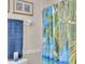 Simple bathroom with shower and tropical shower curtain at 745 Kellstadt Nw St, Port Charlotte, FL 33952