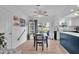 Bright dining area with a wooden table, blue chairs, and access to the backyard at 745 Kellstadt Nw St, Port Charlotte, FL 33952