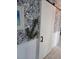 White hallway with barn door and nautical wallpaper at 745 Kellstadt Nw St, Port Charlotte, FL 33952