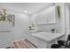 Modern kitchen with white cabinets and corner sink at 745 Kellstadt Nw St, Port Charlotte, FL 33952