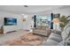 Living room with gray couches, white dresser, and coastal decor at 745 Kellstadt Nw St, Port Charlotte, FL 33952