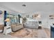 Living room with gray couches, coastal decor, and views of the front yard at 745 Kellstadt Nw St, Port Charlotte, FL 33952