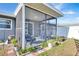 Relaxing screened porch with comfortable seating and backyard access at 745 Kellstadt Nw St, Port Charlotte, FL 33952