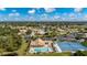 Community pool and tennis courts are seen in this aerial view at 8326 Creekview Ln, Englewood, FL 34224