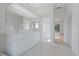 Modern bathroom with double vanity, walk-in shower, and access to a bedroom at 8326 Creekview Ln, Englewood, FL 34224