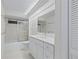 Clean bathroom with white vanity and bathtub at 8326 Creekview Ln, Englewood, FL 34224