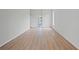 Large bedroom with light wood floors and access to a bathroom at 8326 Creekview Ln, Englewood, FL 34224