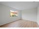 Well-lit bedroom with large window and wood-look floors at 8326 Creekview Ln, Englewood, FL 34224