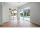 Open dining room with sliding glass doors leading to a pool and patio at 8326 Creekview Ln, Englewood, FL 34224