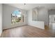 Open dining room with hardwood floors and large window at 8326 Creekview Ln, Englewood, FL 34224