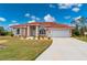 Single story house with tile roof, landscaping, and attached garage at 8326 Creekview Ln, Englewood, FL 34224