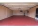 Attached garage with painted floor and open door at 8326 Creekview Ln, Englewood, FL 34224
