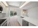 Bright kitchen with white cabinets, quartz countertops, and stainless steel appliances at 8326 Creekview Ln, Englewood, FL 34224