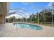 Relaxing kidney-shaped pool with screened enclosure at 8326 Creekview Ln, Englewood, FL 34224