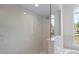 Bright shower with glass enclosure and neutral tile at 8326 Creekview Ln, Englewood, FL 34224
