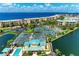 Drone view of community pool, tennis courts and waterfront at 87 Vivante Blvd # 403, Punta Gorda, FL 33950