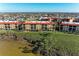 Waterfront condo community, showcasing multiple buildings and landscaping at 87 Vivante Blvd # 403, Punta Gorda, FL 33950