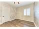 Bright bedroom with wood floors, white door and window shutters at 87 Vivante Blvd # 403, Punta Gorda, FL 33950