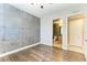Spacious bedroom with wood floors and an accent wall at 87 Vivante Blvd # 403, Punta Gorda, FL 33950