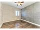 Guest bedroom with wood floors, an accent wall and a private bathroom at 87 Vivante Blvd # 403, Punta Gorda, FL 33950