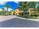 Condo building with a yellow facade, palm trees and landscaping at 87 Vivante Blvd # 403, Punta Gorda, FL 33950